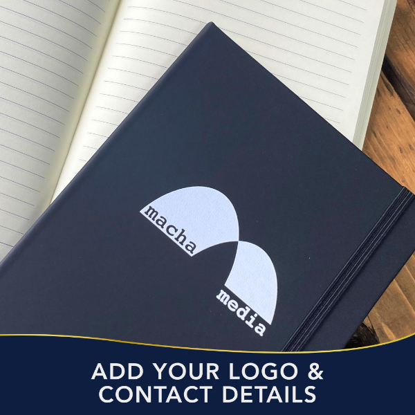 Dark blue notebook with 'macha media' logo on a wooden surface