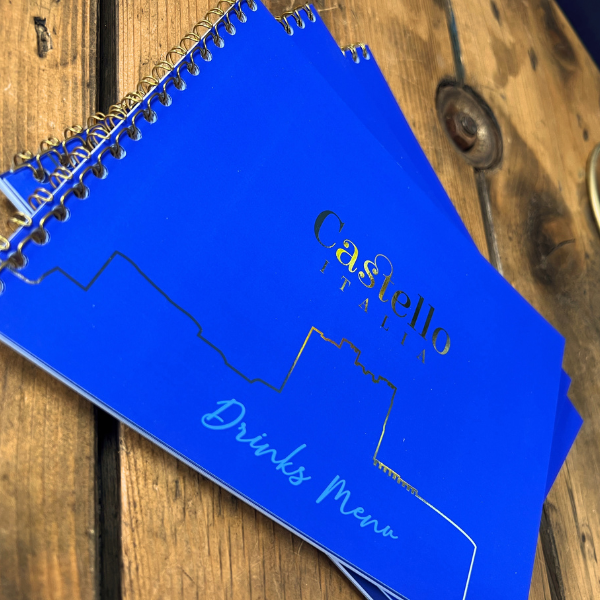 Castello Italia Blue Wire bound booklet with gold foil on wooden table