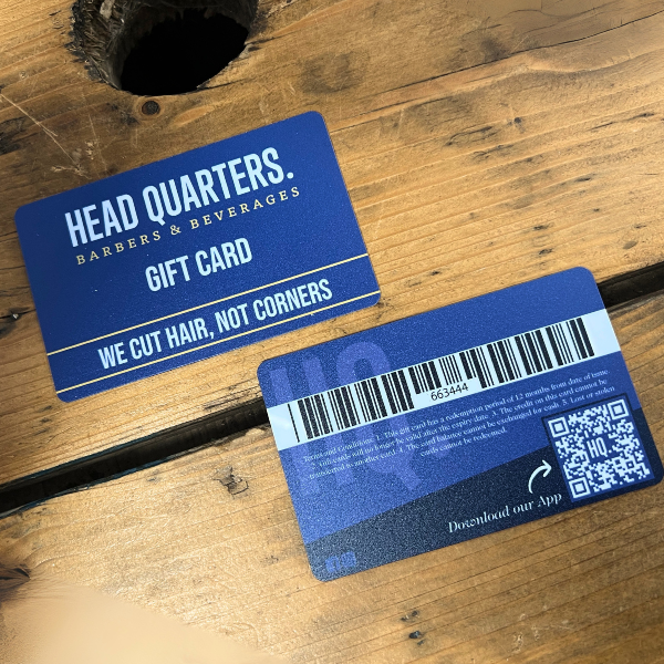 Two blue head quarter UV printed gift cards front and back on wooden table