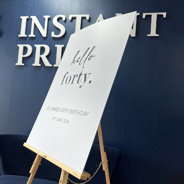 40th Birthday Foamex Board on an easel infront of Instant Print sign