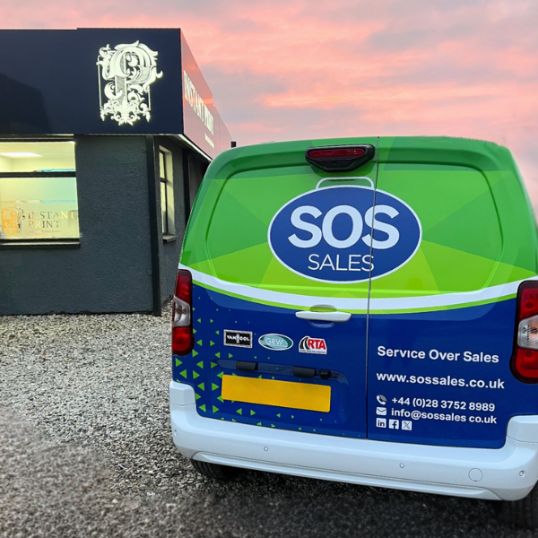 Blue and green vehicle wrap infront of Instant Print NI