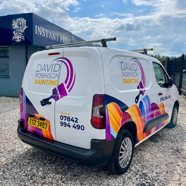 Van with 'David Robinson Painting' branding and colorful design on a gravel surface.