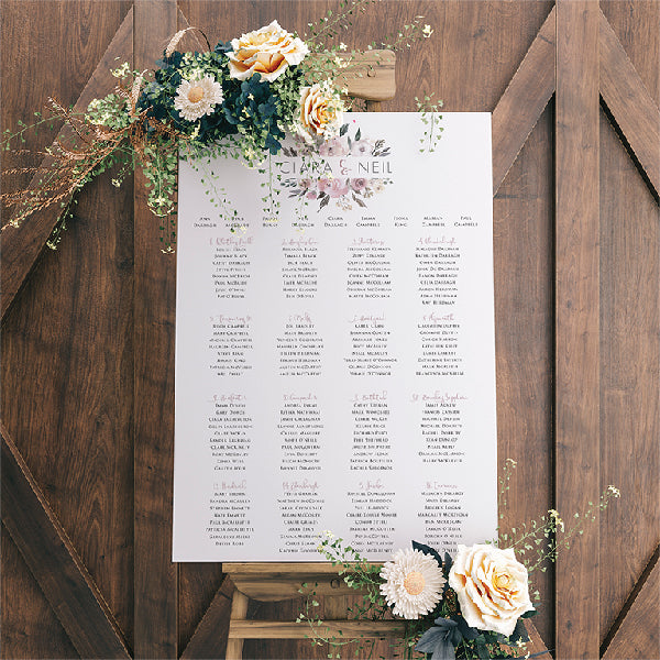 A1 Wedding Seating Plan, with a floral design, positioned on a wooden easel
