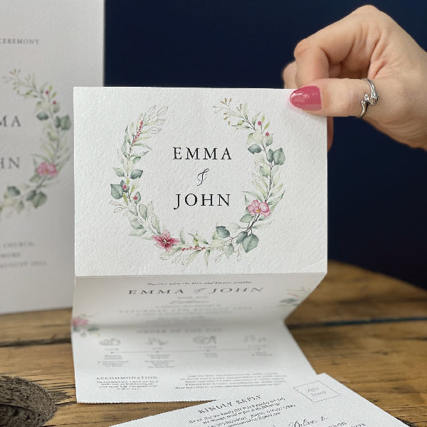 Z-folded Wedding Invitation, printed on Tintoretto Textured Card, with a floral semi-circle.