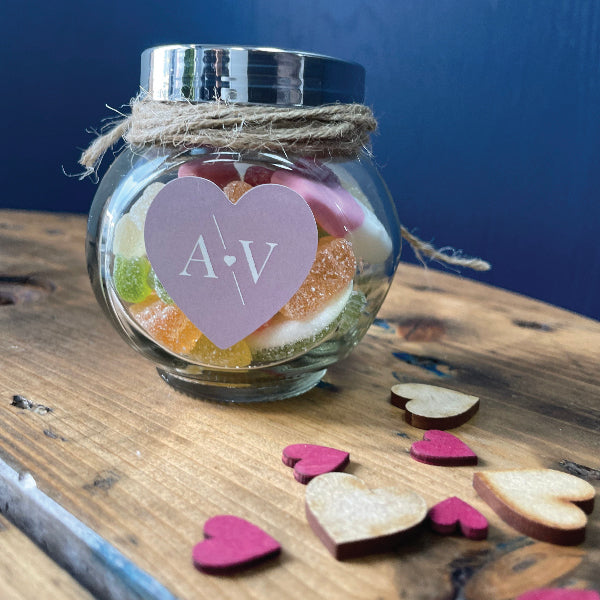 Pink Heart Shaped Wedding Sticker with the initials AV, on a jar with sweets as a wedding favour.