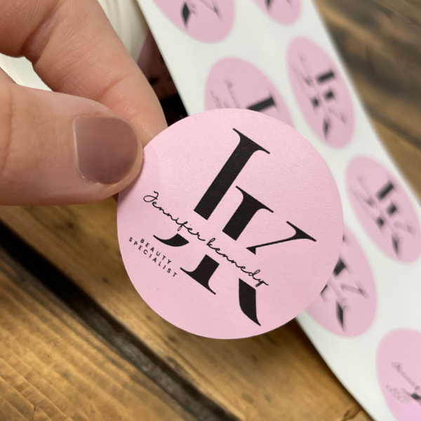 pink small circle sticker being held to show camera for JK beauty specialist