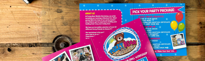 Pink Teddy Bear Brochure on Wooden Table