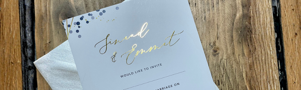 Gold Foil wedding invitation with pearlised envelop on wooden table