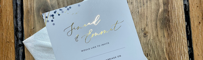 Gold Foil wedding invitation with pearlised envelop on wooden table
