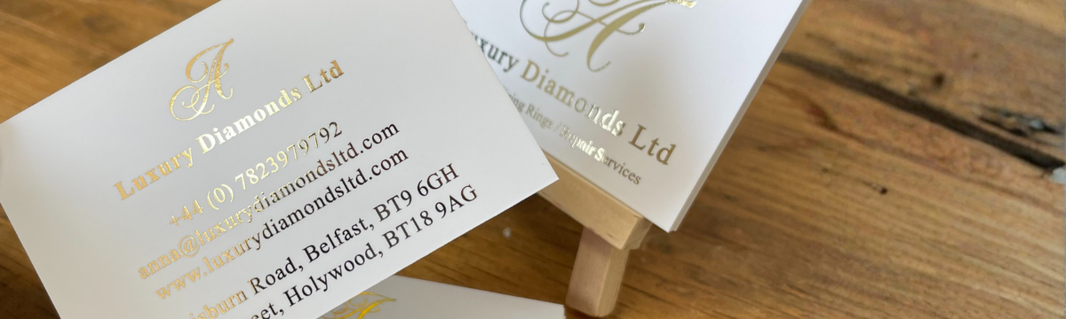 Rose gold foil business cards on wooden easle