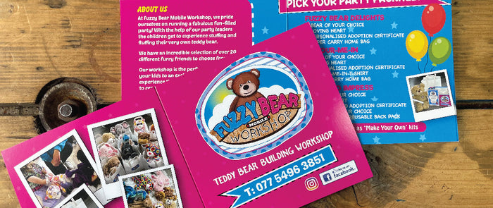 Pink Teddy Bear Brochure on Wooden Table