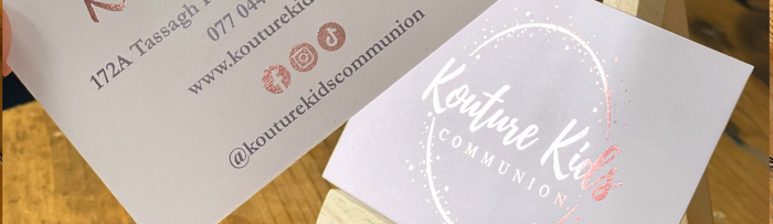 Rose gold foil business cards on wooden easle