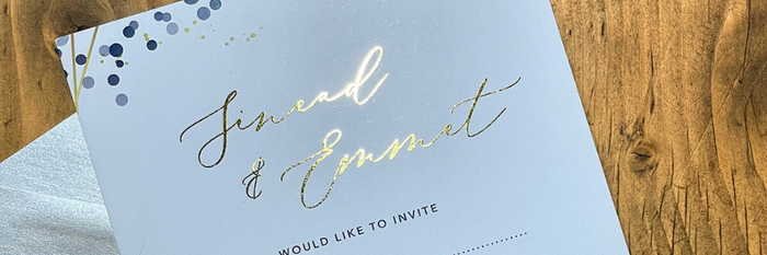 Gold Foil wedding invitation with pearlised envelop on wooden table