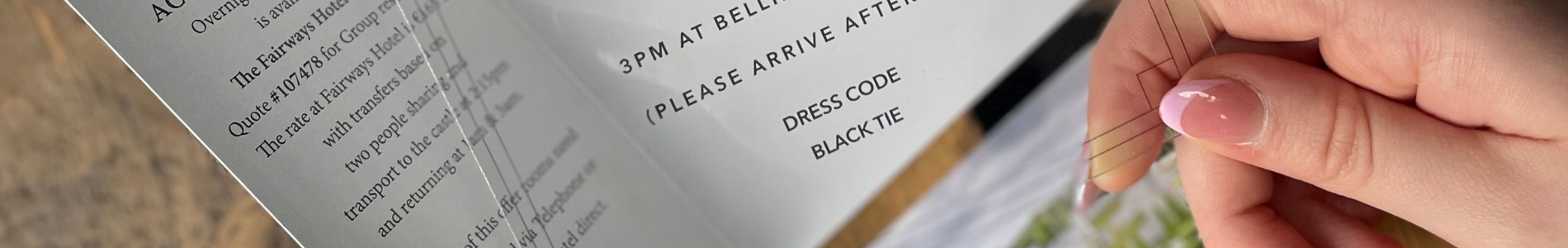 Acrylic Wedding Invite being held with a hand