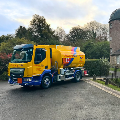 Yellow and blue tanker truck with 'Estuary Oils' branding on a road.