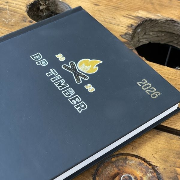 2026 Branded Diaries with DP Timber Logo UV Printed on the Cover on a wooden table