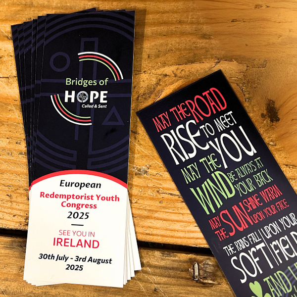 Personalised bookmarks for Bridges of Hope event on a wooden surface