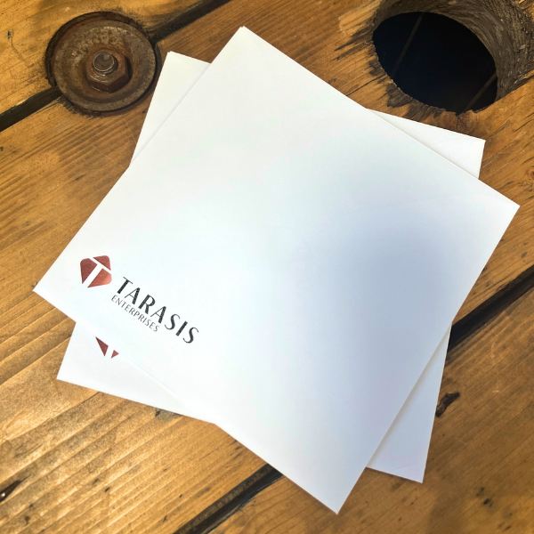 Branded Envelops with Tarasis logo on a wooden surface