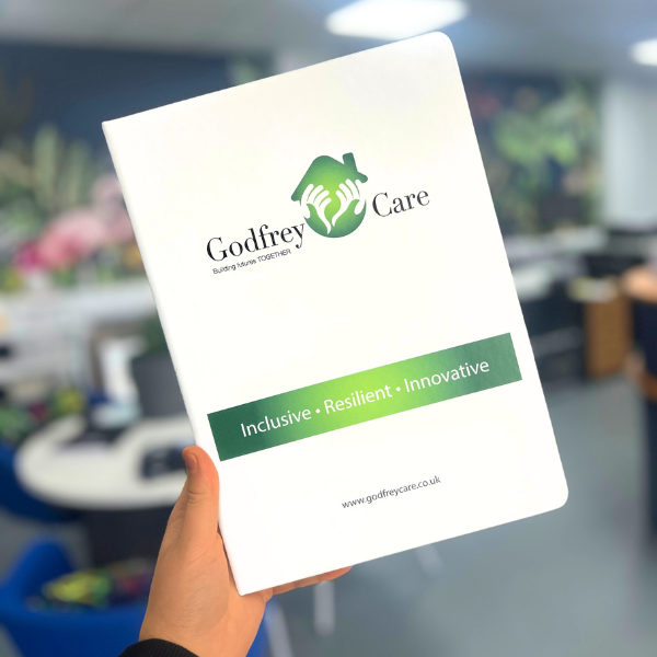 A4 White Notebook reads 'Godfrey Care'