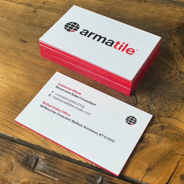 Stack of Armatile business cards on a wooden surface