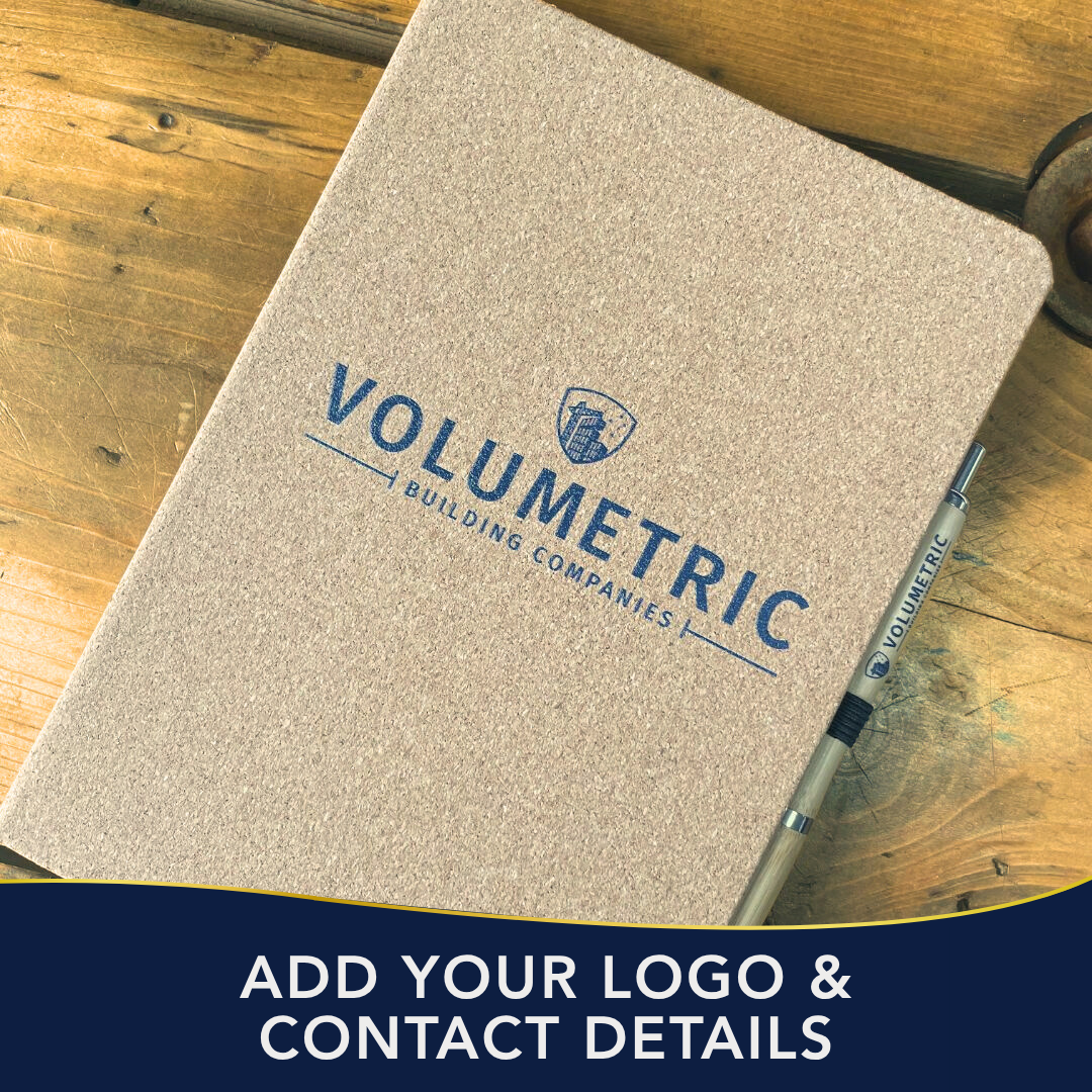Notebook with 'Volumetric Building Companies' logo on a wooden surface