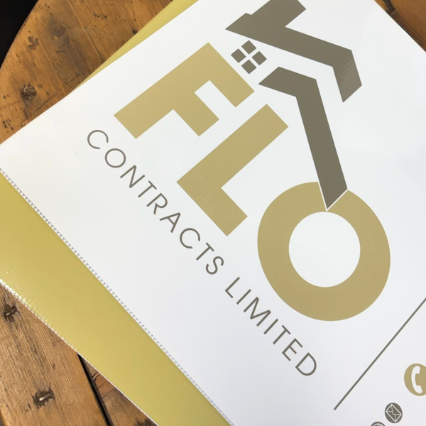 Flo contracts green and white correx boards stacked on wooden table