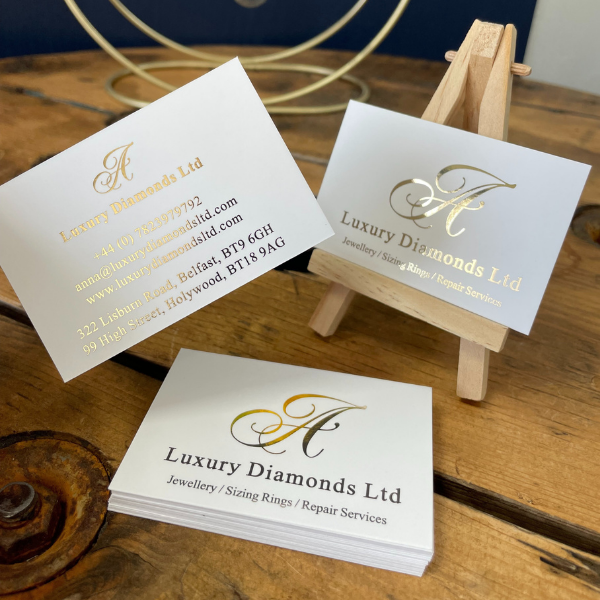 Business cards for Luxury Diamonds Ltd on a wooden surface