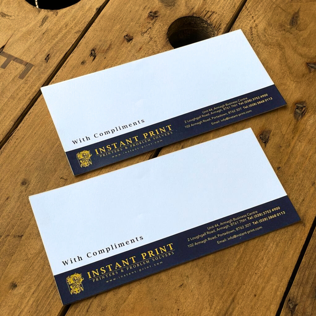 instant print ni compliment slip on a wooden table