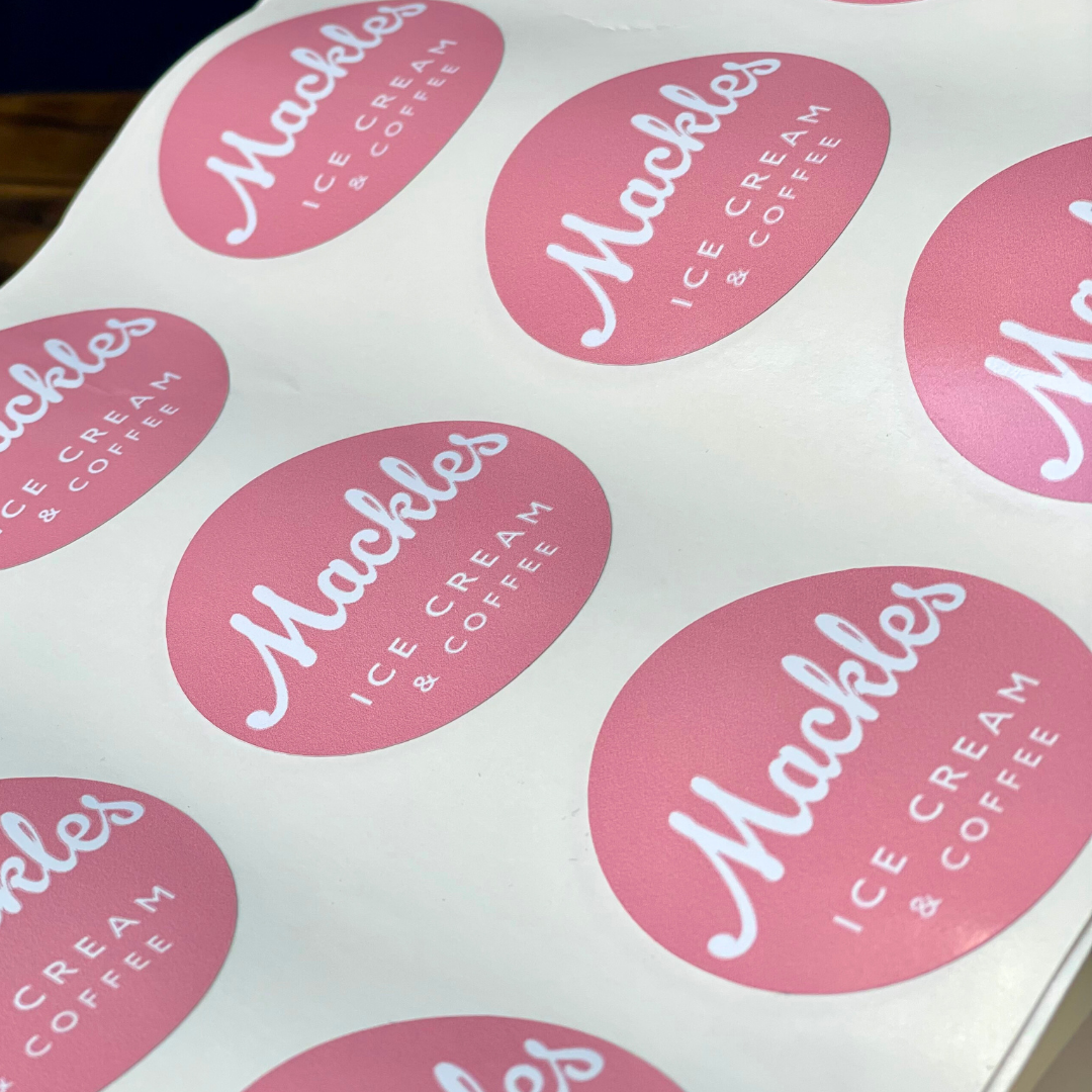 Pink stickers with 'Mackles Ice Cream & Coffee' text on a white background
