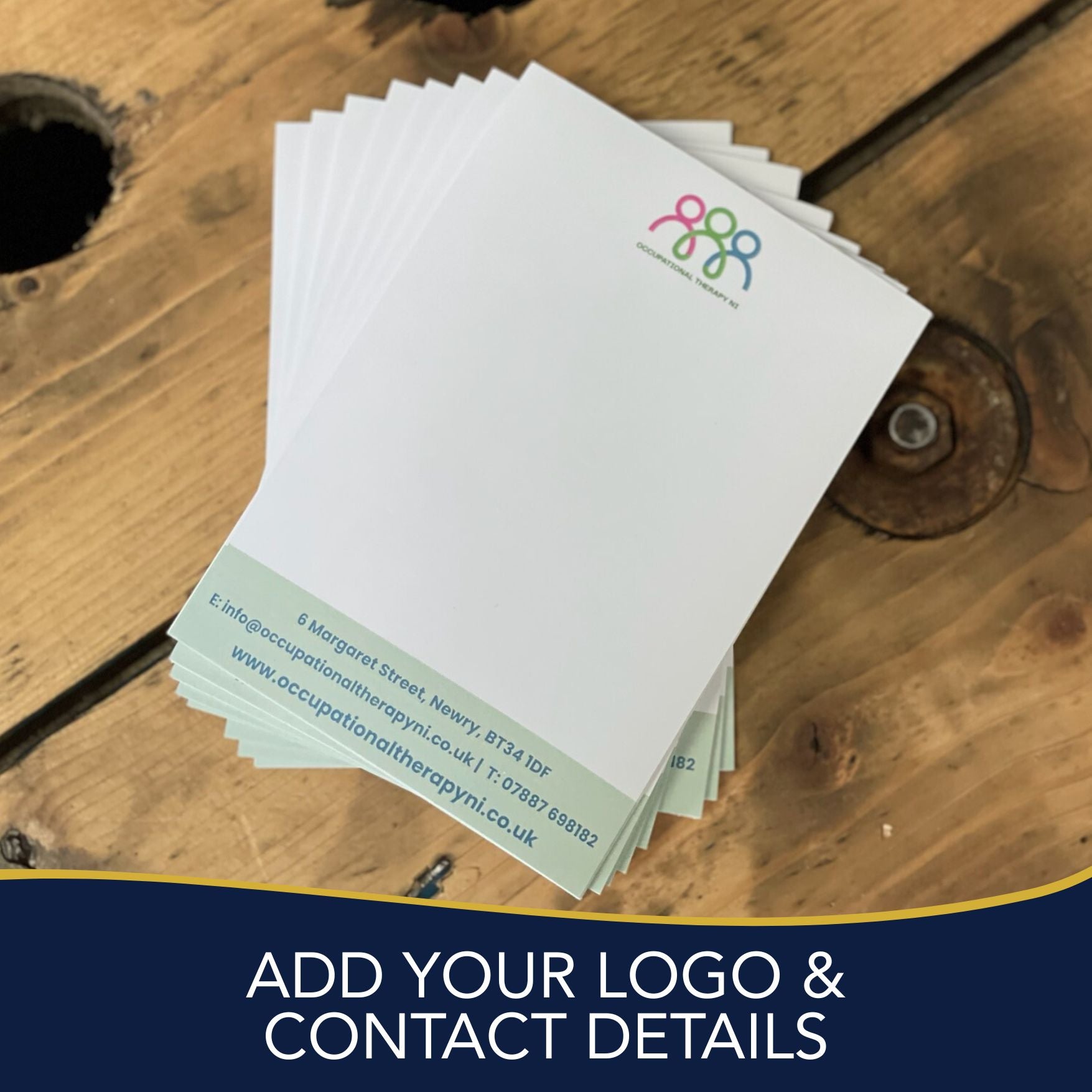 Stack of notepads on a wooden table with TEXT "add your Logo and Contact Details"