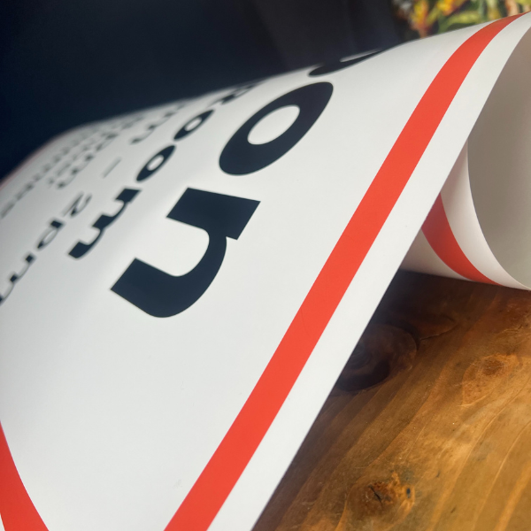 Red and white paper banner on wooden table