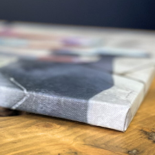 Canvas lying on a wooden surface with a blurred background