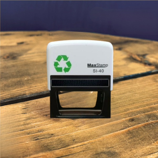 MaxStamp SI-40 stamp with recycling symbol on a wooden surface
