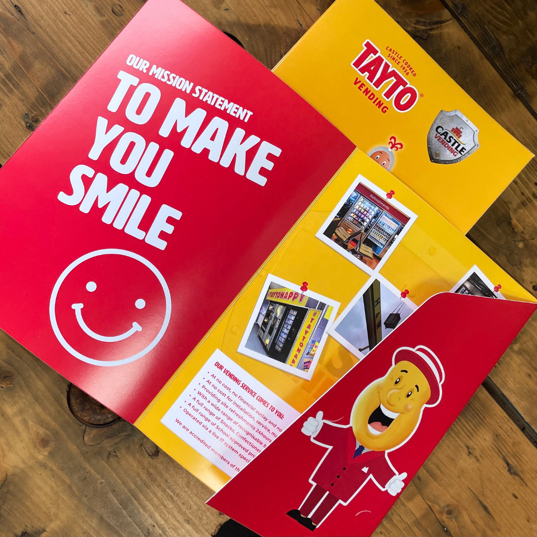 Tayto folder with a red and yellow design on a wooden surface