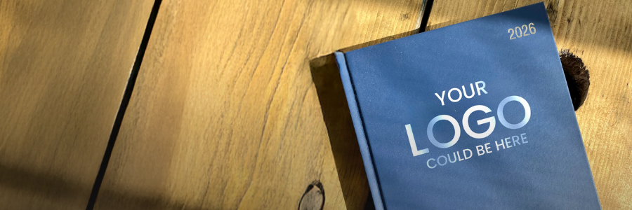 Blue book with 'Your Logo Could Be Here' text on a wooden surface