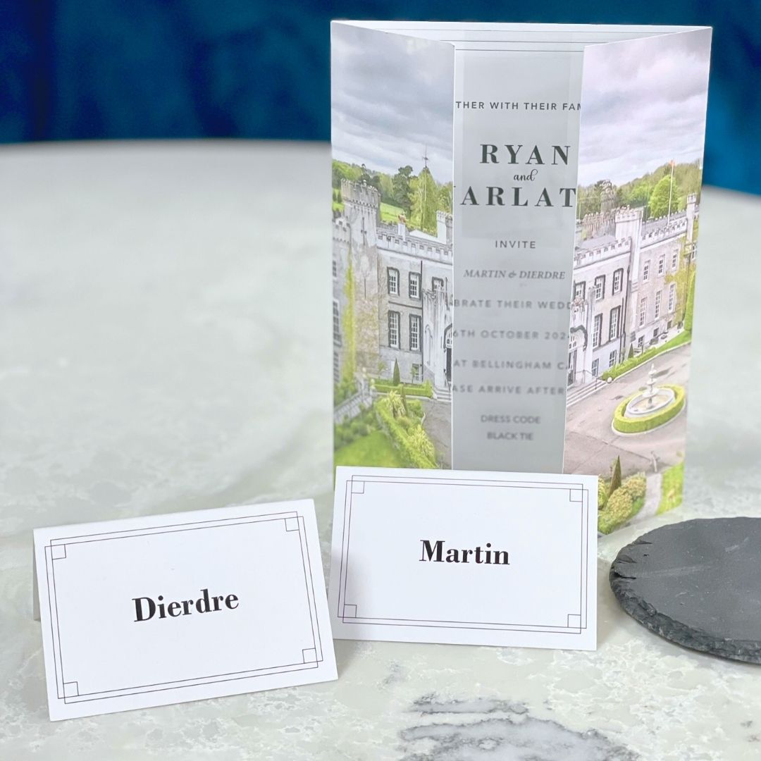 Wedding Place Names for Dierdre and Martin positioned on a marble table with matching wedding invitation