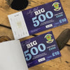 Tickets bing flicking through, showing different numbering on a wooden surface