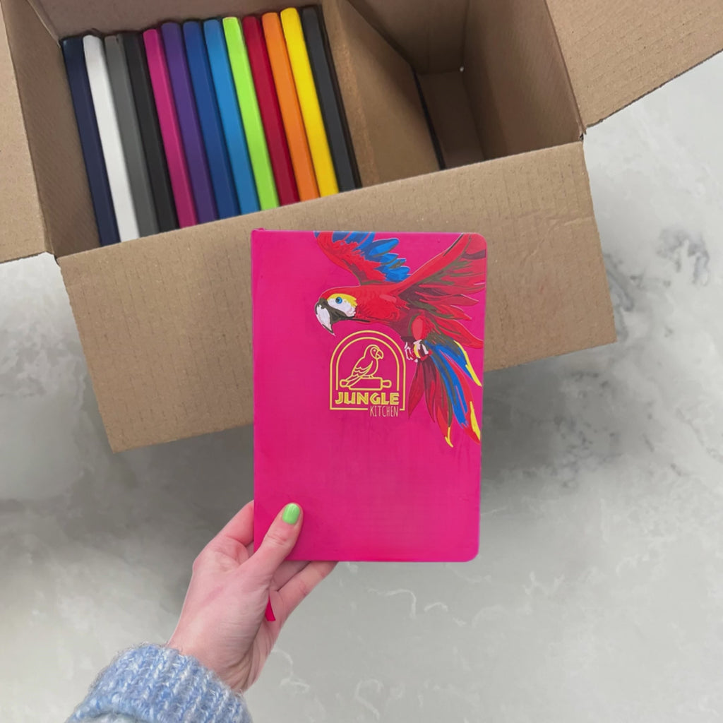 Pink Personalised Branded Notebook shown in different places around Armagh City