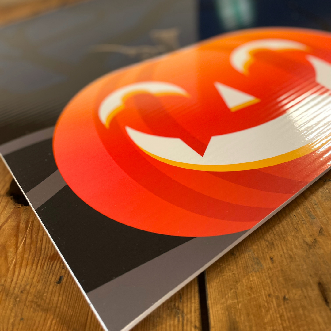 Close-up of a pumpkin printed on to correx board on top of wooden table